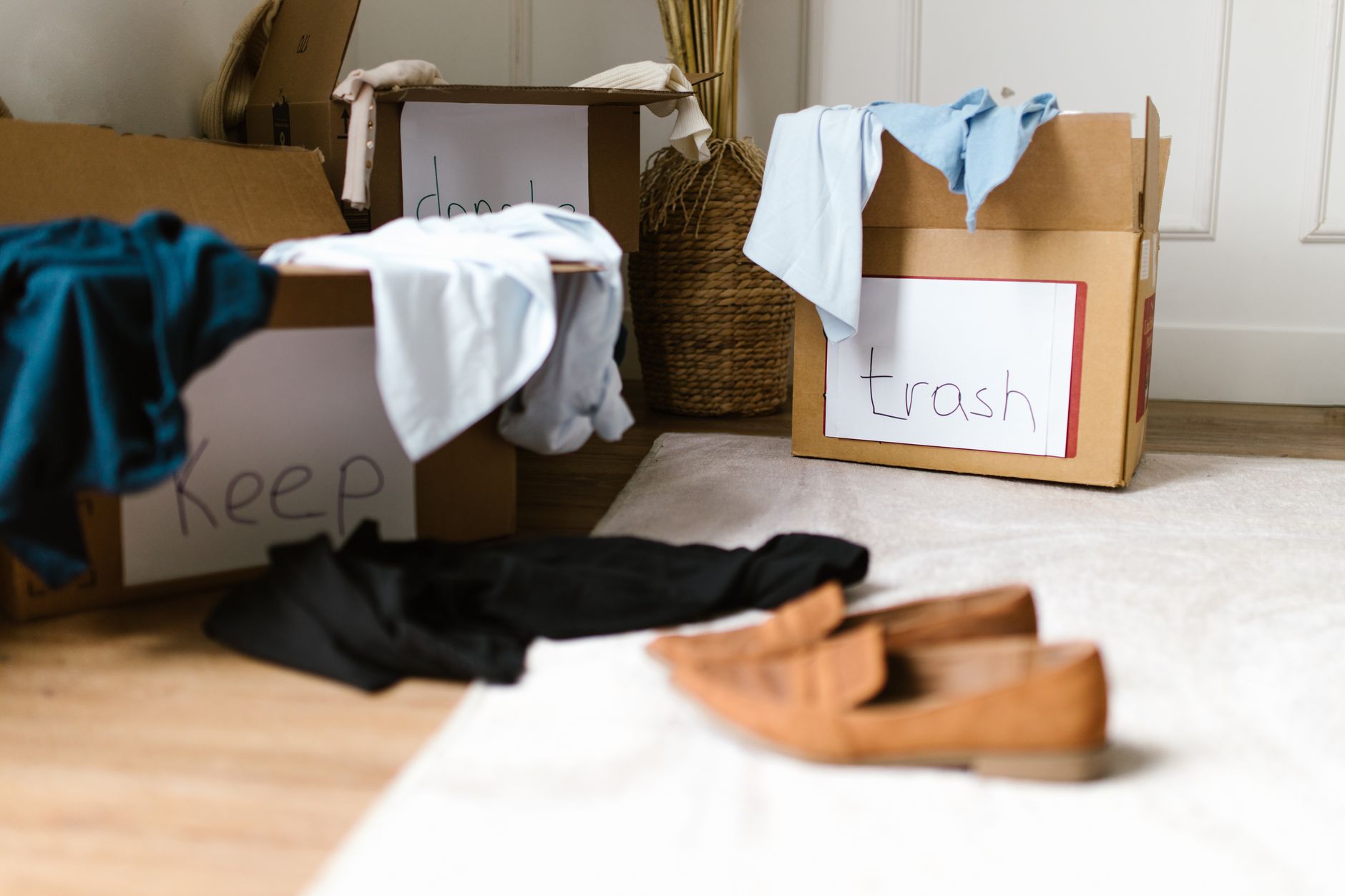 A cluttered room with boxes and items scattered around
